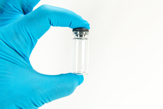 Glass bottle for vaccines on white background