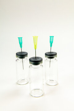 Glass bottle for vaccines on white background