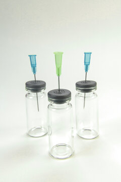 Glass bottle for vaccines on white background