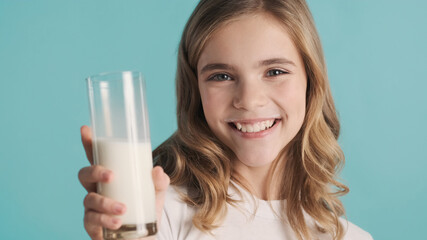 Close up smiling blond teenage girl looking cute posing with gla