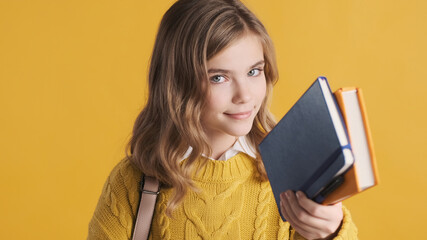 Portrait of teenager student girl dressed in yellow sweater posi