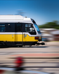 Fototapeta na wymiar Subway Train in Action Moving Thru Suburban Area, Moving Railway Train with Motion Blur, Modern Public Transport at High Speed