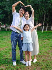 Fototapeta premium Happy family of three playing in the park