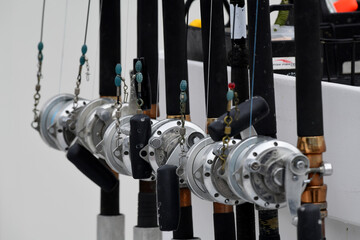 Professional-grade rods and reels on a fishing boat in the harbor at Seward, Alaska, wait for...