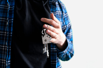 human hand holding a key from home, symbol of apartment real estate purchase