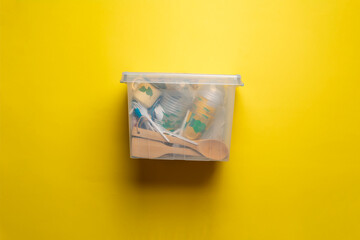 transparent plastic container box with some things at home