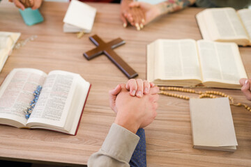 Catholic people praying in Bible study group