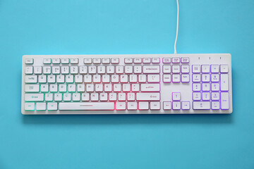 Modern RGB keyboard on turquoise background, top view - obrazy, fototapety, plakaty