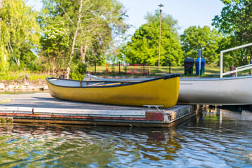 Fototapeta na wymiar Canoes on a dock on the Toronto Islands on a sunny June afternoon.