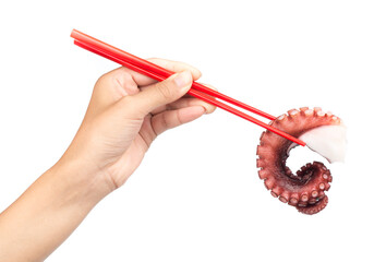 Hand holding chopsticks, eating tentacles of octopus isolated on white background