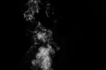 White smoke on black background. Figured smoke on a dark background. Abstract background, design element