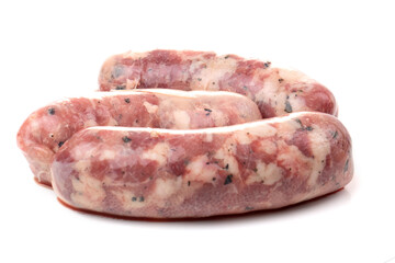 Raw homemade breakfast sausages isolated on a white background.