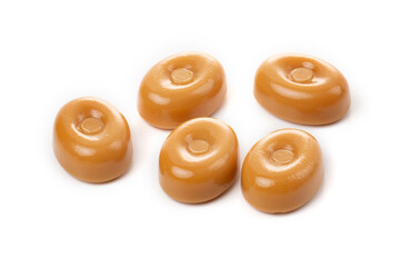 Caramel candies on a white background close-up.