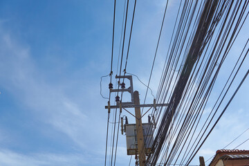Fototapeta premium Electrical poles on the power line to each pole. Energy for the community and the family.Internet Cable TV 