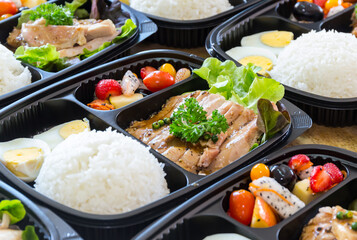 Modern Thai food lunch boxes in plastic packages. Thai rice with pork steak.