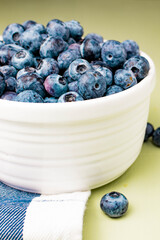 closeup of bowl of ripe blueberries on towel