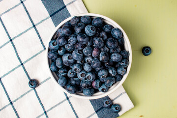 top view of bowl of ripe blueberries on towel