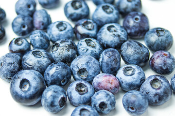 close up of ripe blueberries in group on white background