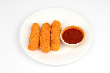 The crispy cheese sticks were placed on a white plate with ketchup in a small bowl, placed next to it and separated from the white background.