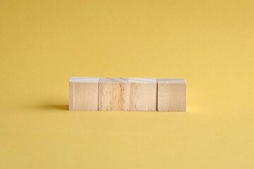 4 letter blank and wood blocks on yellow background.