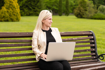 Image of elegant employer sitting on the bench