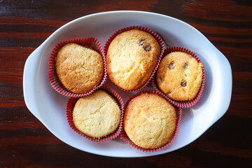 baked chocolate chip cup cakes on a white plate