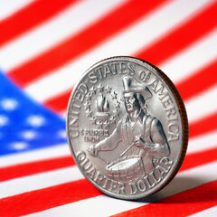 US quarter dollar coin with drummer close-up and USA flag. Stars and stripes in the blur. Beautiful...