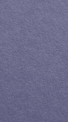 The surface of purple blue cardboard. Grey paper texture with cellulose fibers. Dark natural mobile phone wallpaper. Generic gray vertical background. Top-down. Macro
