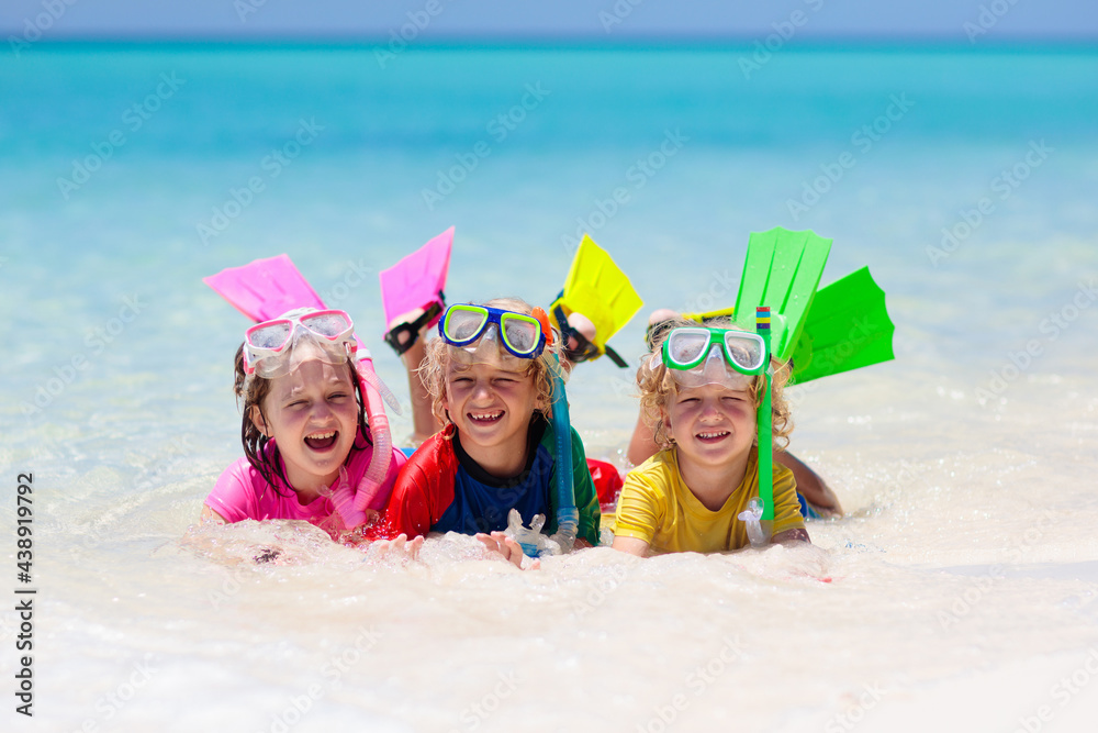 Wall mural kids snorkel. children snorkeling in tropical sea.