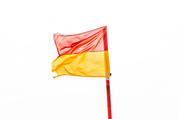 red and yellow flags to indicate to swim between these flags while at the beach isolated on a white background