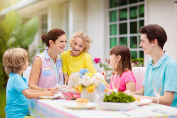 Family eating outdoor. Garden summer fun.
