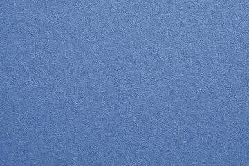 The surface of blue cardboard. Paper texture with cellulose fibers. Elegant tinted background. Glamorous generic gray paperboard wallpaper. Beautiful textured backdrop. Top-down. Macro