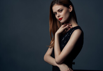 Naklejka premium attractive woman in black dress cosmetics red lips charm glamor dark background