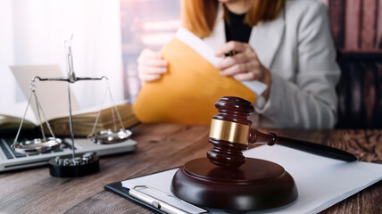 Business and lawyers discussing contract papers with brass scale on desk in office. Law, legal services, advice, justice and law concept