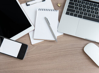 Laptop with office supplies on the table.