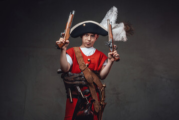 Little kid dressed in pirate outfit with guns