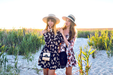 Traveling together, two pretty woman posing on countryside