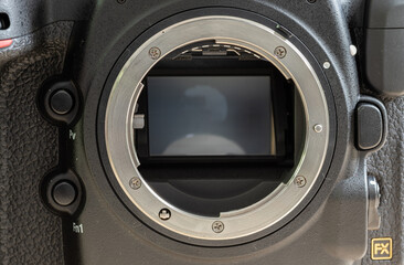 Full-frame 35mm 46megapixel BSI CMOS sensor and the metal mount of a modern DSLR camera close up photograph,
