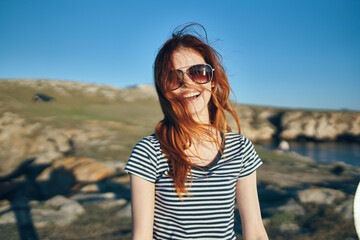 young traveler in t-shirt walking on the beach near the lake summer vacation high mountains