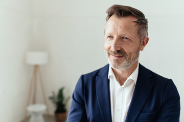 Intrigued businessman looking aside with a fascinated expression