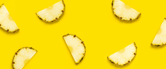Pineapple slice against on a yellow background. Top view, flat lay. Banner