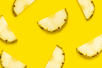 Pineapple slice against on a yellow background. Top view, flat lay