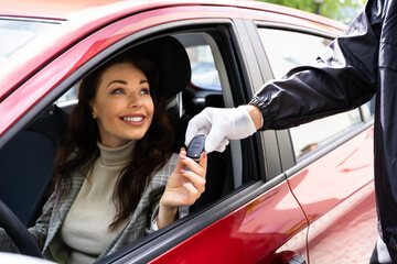 Valet Parking Giving Car Key To Woman