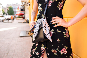 Outdoor fashion portrait of stylish blonde woman wearing sexy vintage midi floral dress