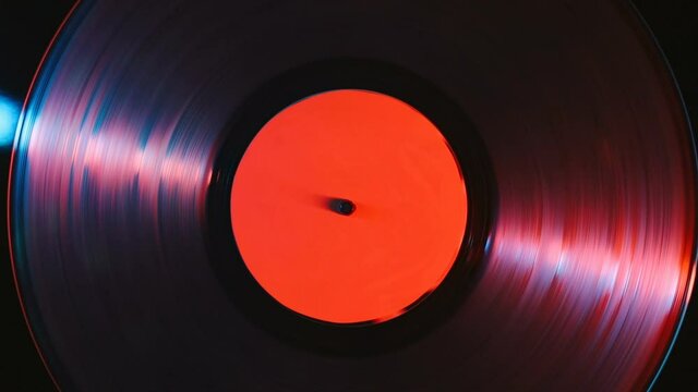 Close up of gramophone vinyl record playing music at night club