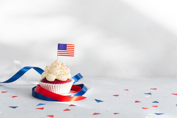 Patriotic cupcake with American flag decorated with ribbons, the 4th of July celebration.