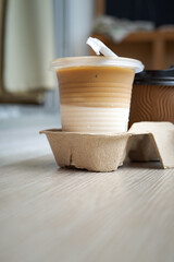 Blurry low angle view of latte coffee condensation in a takeaway cups with a hot coffee.