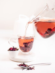 cup of  herbal tea with red rose 