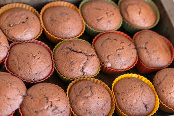Freshly made chocolate muffins on a baking tray. homemade baking. Close-up.