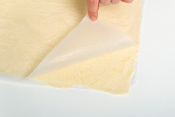 Process of making apple pie, strudel. Thinly rolled dough in parchment.
